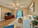 Cozy living room featuring a ceiling fan and sliding glass doors at 10800 Us Highway 19 N # 127, Pinellas Park, FL 33782