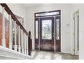 Elegant front entryway with a decorative glass door and tile flooring, creating a welcoming ambiance at 11029 Lynn Lake Cir, Tampa, FL 33625