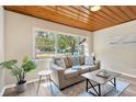 Cozy living room featuring a large window, comfortable seating, and stylish decor at 1128 S 70Th St, Tampa, FL 33619
