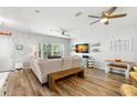 Bright living room featuring wood floors, fan, neutral furniture, and natural light at 1271 Drew St, Clearwater, FL 33755