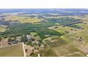 An aerial perspective reveals the property's location among trees, fields, and neighboring houses, close to the area at 14409 Curley Rd, Dade City, FL 33525
