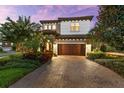 Beautiful two-story home featuring a paver driveway and meticulously maintained landscaping at 1570 Marinella Dr, Palm Harbor, FL 34683