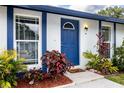 Inviting front door of this home surrounded by colorful plants and manicured landscaping at 16011 Saddle Creek Dr, Tampa, FL 33618