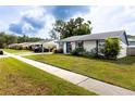 Charming single-story home boasts a well-manicured lawn and inviting curb appeal at 16011 Saddle Creek Dr, Tampa, FL 33618