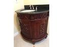 Bathroom with ornate vanity, a black granite countertop, and a decorative vessel sink at 17220 Estes Rd, Lutz, FL 33548