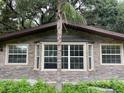 Close-up of the brick facade, bay window, and windows of this house at 17220 Estes Rd, Lutz, FL 33548