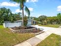 Attractive home boasts a fresh driveway, white privacy fence, well-kept lawn, and appealing landscaping at 2433 Blind Pond Ave, Lutz, FL 33549
