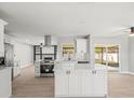 Modern kitchen featuring a central island, stainless steel appliances, and a seamless open-concept layout at 2433 Blind Pond Ave, Lutz, FL 33549