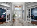 Grand foyer with decorative glass double doors and views into the adjacent rooms at 2903 Manor Ridge Pl, Valrico, FL 33596