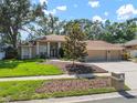 Charming single-story home with a well-maintained lawn, mature trees, and inviting curb appeal at 2903 Manor Ridge Pl, Valrico, FL 33596