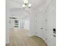 Home foyer with hardwood floors and entry to living room at 307 S Arrawana Ave # 100, Tampa, FL 33609