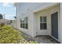 Home front entrance with gray door, brick pathway and lush landscaping at 307 S Arrawana Ave # 100, Tampa, FL 33609