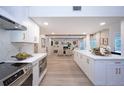 Open-concept kitchen with quartz countertops flows into the living room with fireplace and pool views at 35 Deerpath Dr, Oldsmar, FL 34677