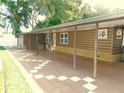 Wide covered parking featuring a checkered pattern design, with convenient home access at 36901 Tara Ave, Zephyrhills, FL 33542