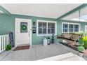 Cozy front porch with a swing, decorative plants, and a welcoming entrance, creating an inviting curb appeal at 4191 Maple Ne St, St Petersburg, FL 33703