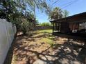 Beautiful backyard featuring a screened-in lanai, lush grass, and mature trees for shade and privacy at 484 Itasca Ave, Tampa, FL 33606