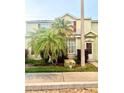 Inviting townhome with mature palm trees and colorful flowerbeds at 6025 Osprey Lake Cir, Riverview, FL 33578