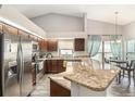 Bright kitchen features stainless steel appliances, granite countertops, and breakfast bar seating at 6118 Becklin Pl, Riverview, FL 33578