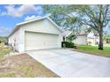 Single-story home with a two-car garage, mature landscaping, and a well-maintained lawn at 7855 Bristol Park Dr., Apollo Beach, FL 33572
