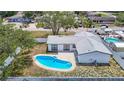 Beautiful home from above, highlighting the refreshing pool, patio, and well-maintained backyard at 10006 N Connechusett Rd, Tampa, FL 33617