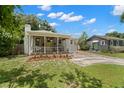 Charming exterior with landscaped yard and covered porch area at 1003 W Indiana Ave, Tampa, FL 33603
