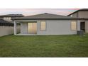 Well-maintained backyard featuring a cozy patio and lush green lawn at 10111 Tuscan Sun Ave, Riverview, FL 33578