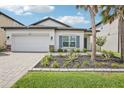 Charming single-story home featuring a paver driveway and beautifully landscaped front yard at 10111 Tuscan Sun Ave, Riverview, FL 33578