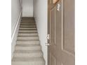 Carpeted staircase with white railings leading upstairs from entry at 10511 Waterview Ct # 10511, Tampa, FL 33615