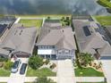 Aerial view showcasing a well-maintained home with a private backyard and serene lake view at 11684 Brighton Knoll Loop, Riverview, FL 33579