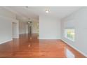 Bright living room featuring gleaming hardwood floors and a vaulted ceiling at 11741 Teapot Ct, Spring Hill, FL 34609