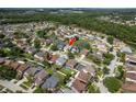 Aerial view showcases the home's location within a well-planned community with a pond at 1246 Ocean Reef Rd, Wesley Chapel, FL 33544