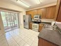 Bright kitchen featuring stainless steel appliances, ample counter space, and access to the screened lanai at 15922 Fishhawk Creek Ln, Lithia, FL 33547