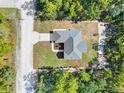 Bird's-eye view of a modern house with a gray roof, set in a lush green landscape at 16247 Little Auk Rd, Weeki Wachee, FL 34614