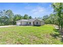 Inviting single-Gathering home with neat front yard and well-maintained lawn under clear sky at 16247 Little Auk Rd, Weeki Wachee, FL 34614