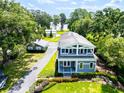 Beautiful two-story home with a manicured lawn, garden beds, and a long driveway at 16603 Hutchison Rd, Odessa, FL 33556