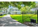 Beautiful two-story home on a lush, green lawn with a charming front garden and mature trees at 16603 Hutchison Rd, Odessa, FL 33556