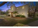 Charming two-story home featuring a bright white exterior, manicured landscaping, and a welcoming front entrance at 1820 Rumar Ln, Holiday, FL 34691