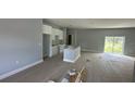 Bright, unfinished open-concept living room with large sliding glass doors and neutral paint at 199 Statler St, Port Charlotte, FL 33954