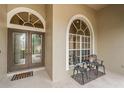 Close-up view of the front entrance with double doors and a seating area at 2143 Edelweiss Loop, Trinity, FL 34655