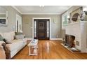 Cozy living room with hardwood floors, fireplace, and a large front door at 2511 W Morrison Ave, Tampa, FL 33629