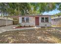 Single-story home showcasing a neatly landscaped yard, carport, and appealing stone facade at 2646 61St N Ave, St Petersburg, FL 33714