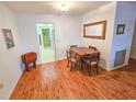 Bright dining room featuring wood-look flooring, neutral paint, adjacent to kitchen at 2850 59Th S St # 310, Gulfport, FL 33707