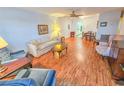 Cozy living room featuring wood-look flooring, neutral paint, ceiling fan, and dining room access at 2850 59Th S St # 310, Gulfport, FL 33707