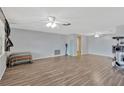 Spacious living room featuring wood-look flooring and abundant natural light at 3547 Odom Dr, New Port Richey, FL 34652