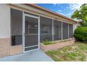 Enclosed porch with tiled accents and space for outdoor seating at 3547 Odom Dr, New Port Richey, FL 34652