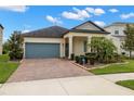 Attractive single-story home featuring a brick driveway, well-maintained landscaping, and inviting front entrance at 3972 Wisdom Trl, Land O Lakes, FL 34638