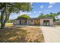 Lovely single-Gathering home showcasing stone accents and a well-manicured lawn, adding to its inviting aesthetic appeal at 4608 Deltona Blvd, Spring Hill, FL 34606