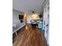Comfortable living room featuring wood flooring, a sectional sofa, and an open view to the kitchen at 51 Island Way # 309, Clearwater Beach, FL 33767