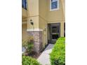 The front door is flanked by a stone column and well-manicured shrubs at 5529 White Marlin Ct, New Port Richey, FL 34652