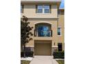 Townhouse with a second-story balcony, a garage, and well-maintained landscaping at 5529 White Marlin Ct, New Port Richey, FL 34652